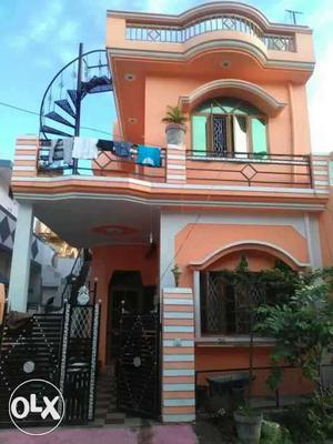 Orange And White Concrete 2-storey House With Black Gate