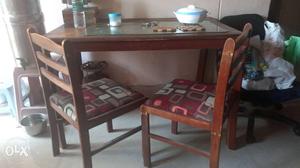 Rectangular Brown Wooden Table With Padded Chairs