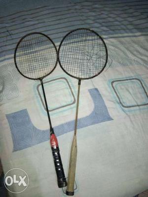 Two old playing different rackets not broken one