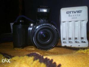 Black DSLR Camera With Envie Battery Charger