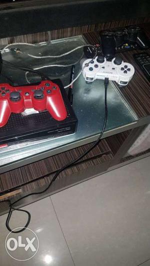 Black Xbox One Console With Two Red And White Game