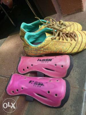 Pair Of Yellow Cleats And Pink Shin Guards