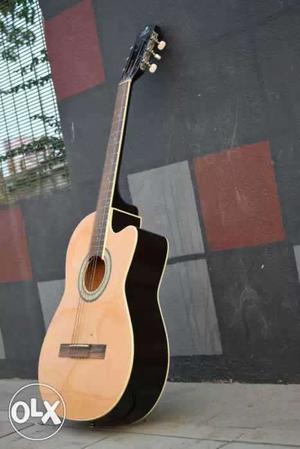 Brown And Black Wooden Cutaway Guitar