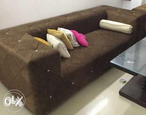 Elegant brown coloured 3 seater sofa