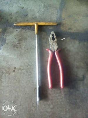 Red Linesman Pliers And Yellow T-handle Lug Wrench