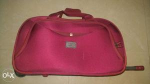 Red polyester duffel bag with trolley. sparing