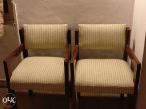 Two Brown Wooden Framed White Padded Armchairs