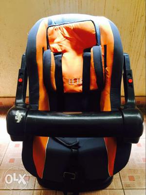Baby's Orange And Black Car Seat