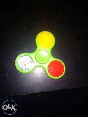 Green, Yellow, White, And Red Hand Spinner