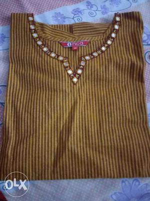 A casual kurta with mirror work neck line