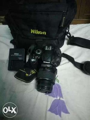 Black Nikon DSLR Camera And Charger With Bag