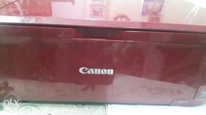 Red Canon Pixma Printer with five supported in a working