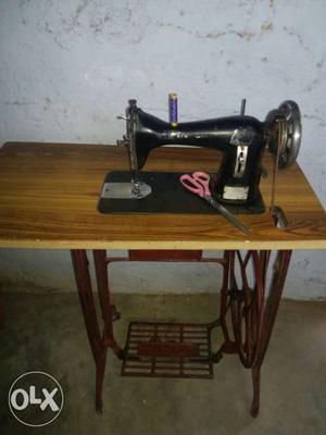 Black Sewing Machine With Brown Desk