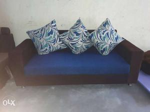Blue And Black Couch With Three Multicolored Throw Pillows