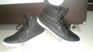 Pair Of Black Leather High Top Sneaker