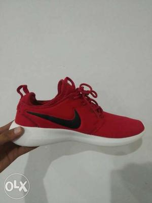 Paired Red Nike Low-top Sneaker
