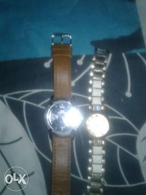 Two Round Silver Watches With Brown Leather Strap And Silver