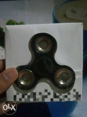 Black and golden fidget spinner in window box package.
