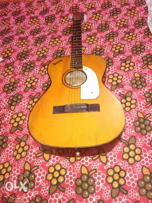 Givson acoustic guitar with cover. It needs fret adjustment.