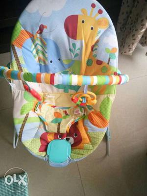 Baby's Green, Orange, And Blue Bouncer