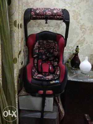 Baby's Red And Brown Car Seat Carrier