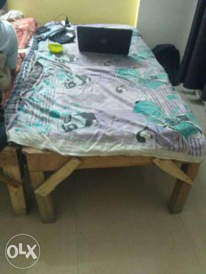 Purple, White, And Green Blanket And Black Laptop Computer