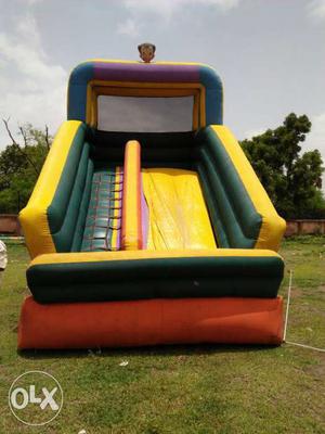 Yellow, Green, And Orange Inflatable Slide