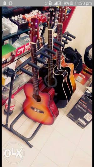Brown And Black Cutaway Acoustic Guitars Screenshot