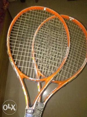 Pair Of Orange Tennis Rackets