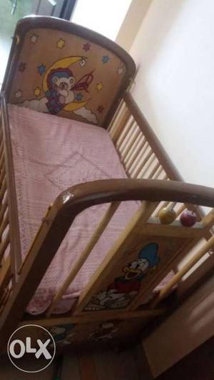 Wooden kid cot with 2 drawers.