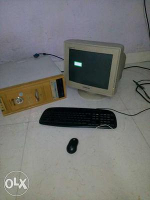 Beige CRT Television, Computer Tower, And Corded Mouse And