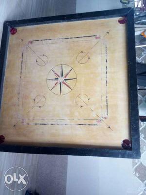 Brown, Black, And Red Carrom Board