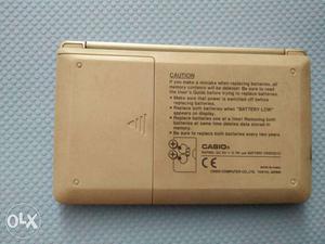 Brown Casio Device calculator and digital diary used to save