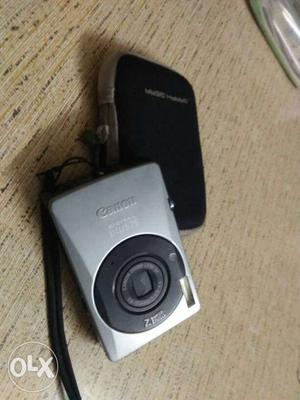 Gray Canon Point-and-shoot Camera With Black Pouch