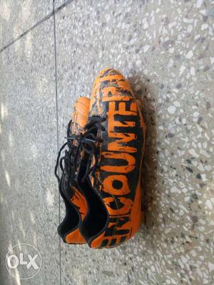 Orange-and-black Encounter Cleats