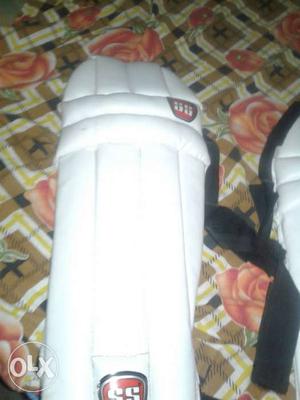 Two White And Black Shin Guards