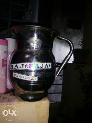 A steel jug. with lid cover.