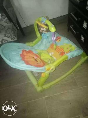 Baby's Blue, Green, And Orange Bouncer Seat