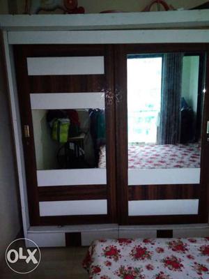 Brown And White Wooden Slide Wardrobe With Mirror