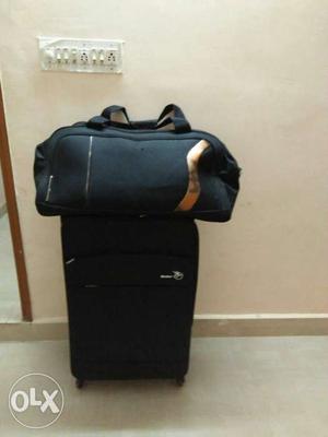 Gray Duffel Bag With Black Luggage Bag