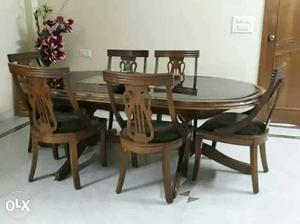 Oval Brown Wooden Dining Table And Padded Chairs Set