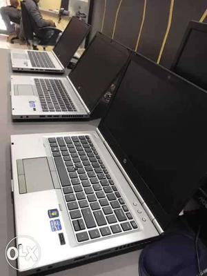 Three Silver-and-black HP Laptops