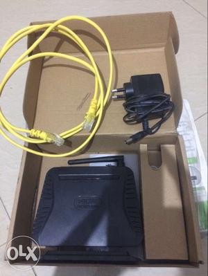 Black Router With Ethernet Cord In Box