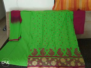 Green and dark pink long sleeves dress material.