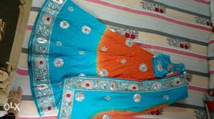 Peach n blue colour lahenga with silver work in