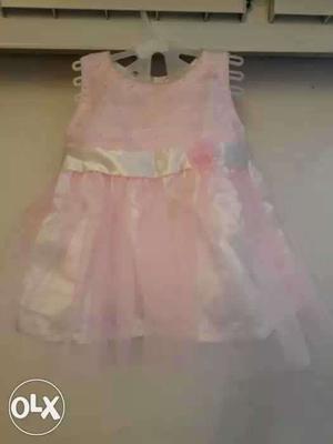 Soft baby pink gathered net infant frock with a