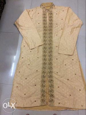 Fawn colour kurta with churidar, embroidered with