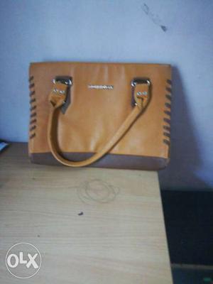 New brand hand bag in mustard color.