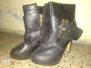 Pair Of Black Leather Zippered Boots