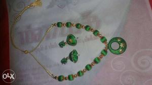Pair Of Green Jhumka Earrings And Bib Necklace